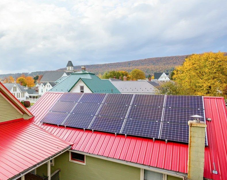 Solar panels installed on a red metal roof in Centre Hall.